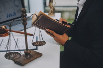 Business and lawyers discussing contract papers with brass scale on desk in office. Law, legal...