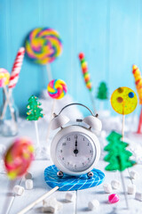 A bright light composition of multi-colored lollipops. Snowman, New Year, Christmas, Sweets,...