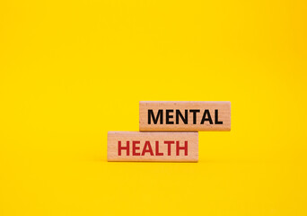 Mental Health symbol. Concept word Mental Health on wooden blocks. Beautiful yellow background. Psychology and Mental Health concept. Copy space - obrazy, fototapety, plakaty