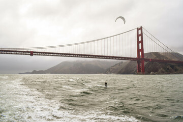 kite surfer under golden gate bridge, san francisco, california