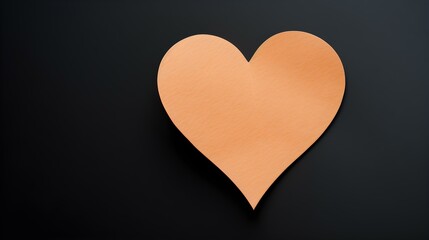 Light Orange Paper Heart on a black Background. Romantic Template with Copy Space