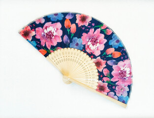 Japanese fan with bright multi-colored flower pattern on white background