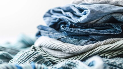 A pile of blue and white clothes neatly stacked on top of each other. Ideal for fashion or laundry-related projects