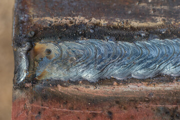 Welding seam on metal close up, welding work with metal