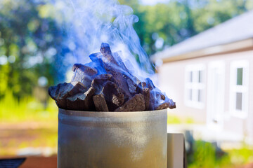 Getting charcoal ready for grill is as easy as using BBQ chimney starter