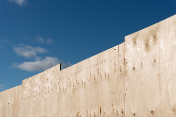 plywood hoarding and blue sky © eugen