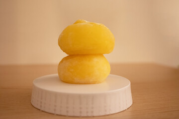 Two yellow mochis on a platform closeup