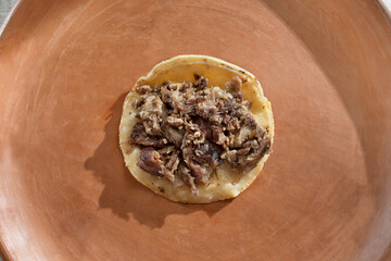 A top down view of a cabeza street taco.
