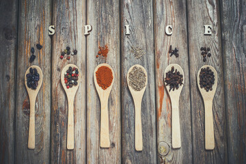 Various spices in wooden spoons, spices, pepper, salt, background with spices