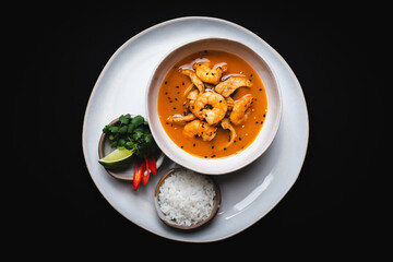 Tom yum, seafood soup. Asian soup on a dark background. Still life