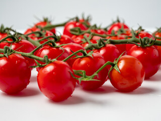 Ripe cherry tomato isolated on white background. Small tomatoes close up.