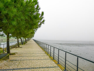 promenade on Portuguese pavement in the Polis of the city of Barreiro on a foggy day.