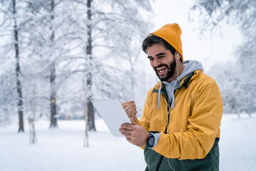 Successful man reading good news on digital tablet pc excited about new business opportunity while...