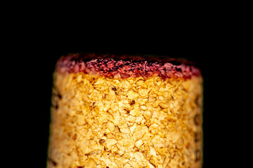 detail of a cork stopper used in a bottle of red wine with a ruby mark absorbed on the contact surface