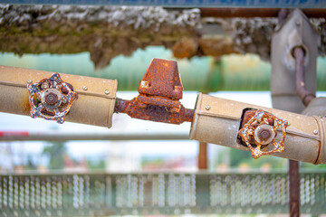 old and rusty faucet of obsolete chemical industrial equipment