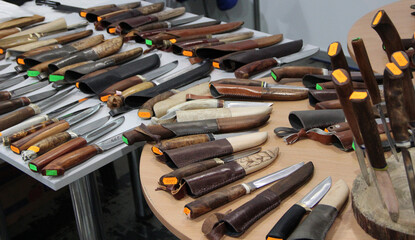 Knives for hunters at exhibition. steel arms