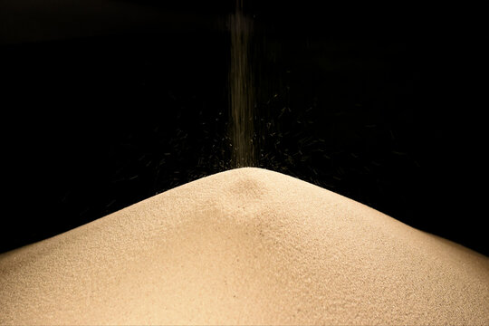 sand clock on black, time is running out, abstract meaning and symbol of time, Dune