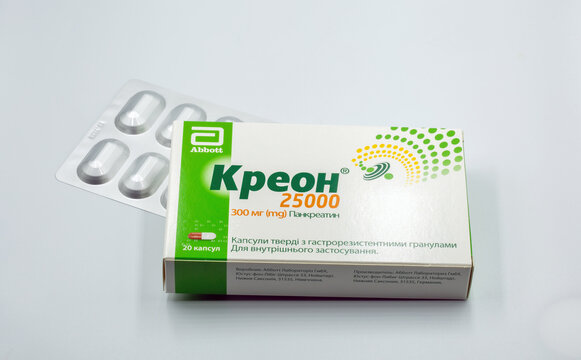 Creon pancreatin pack and blister closeup against white.