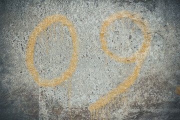 Yellow numbers on a concrete wall, number 09