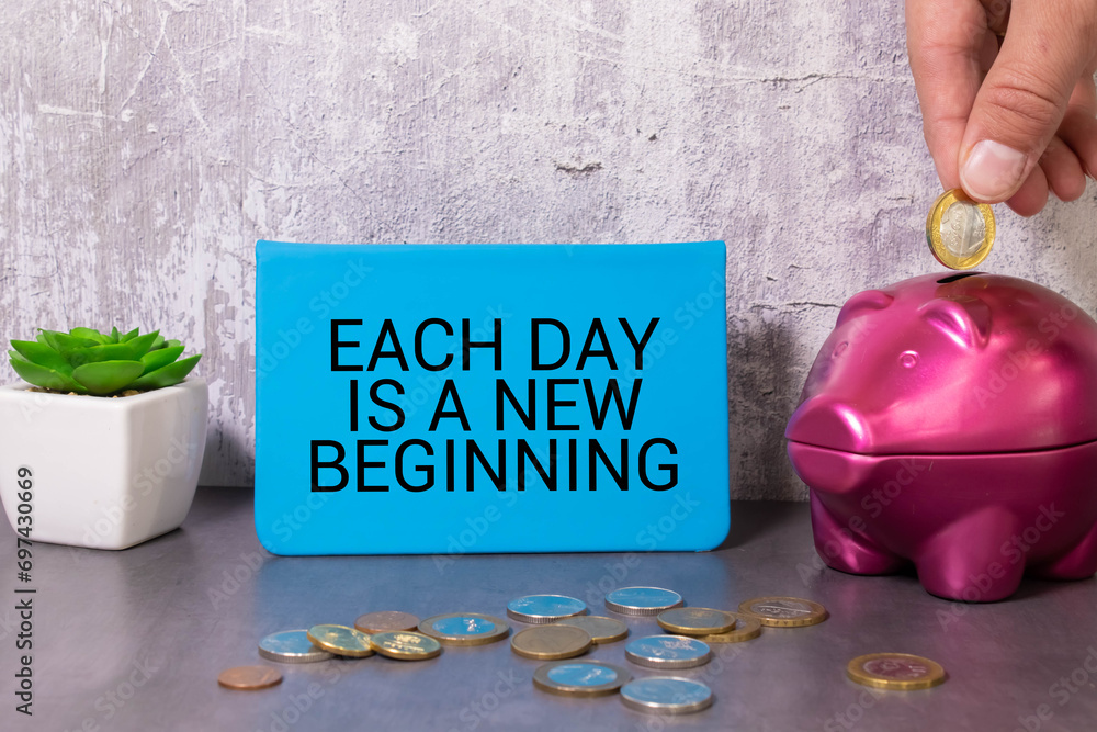 Poster each day is a new beginning - text on a notepad with wrinkled paper and paper needles on wooden back