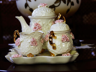 Three Piece Porcelain Tea Set Sitting On Table