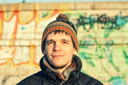 Portrait of a young man wearing a knitted beanie.