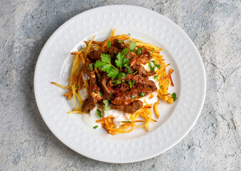 Turkish food; Cokertme Kebab - Beef meat kebab with yoghurt and french fries