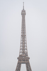 Fototapeta na wymiar The Eiffel Tower alone in the mist of winter rain in Paris 2