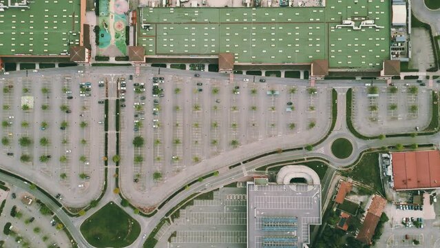 Aerial top down view shot of empty parking lots at the big shopping mall in Italy, retail crisis concept