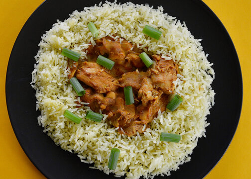 Satay chicken with saffron rice and sliced shallots