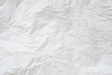 Wrinkled or crumpled white stencil or tissue paper used for crumpled paper background texture