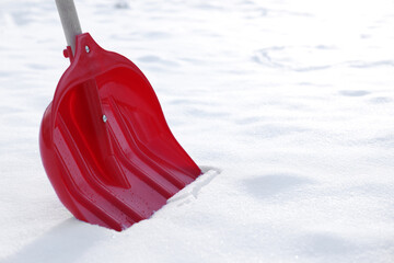 Snow shovel with wooden handle outdoors, closeup. Space for text