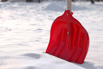 Snow shovel with wooden handle outdoors, closeup. Space for text