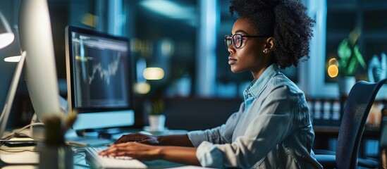 Black female business analyst utilizing computer for African American data