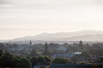 Overlooking Auckland suburbs with Waitakere ranges in the background at dusk