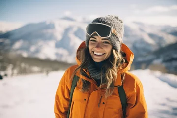 Fotobehang Girl snowboarder in stylish wear and protective glasses enjoy ski resort. Beautiful woman with ski helmet. Winter extreme sport, hobby. Weekend trip and relax concept © ratatosk