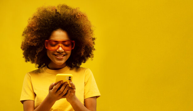 Portrait of inspired dreamy afro american girl use her smartphone think decide what comment look copyspace