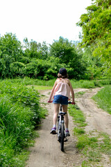 Young girl cyclist enjoy the beautiful sunrise on summer forest trail