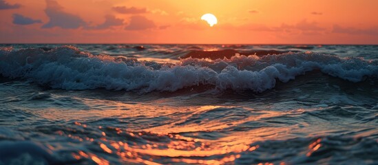 Sunrise causes the sun to tremble above the sea's horizon. - obrazy, fototapety, plakaty