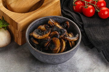 Roasted champignon mushrooms in the bowl