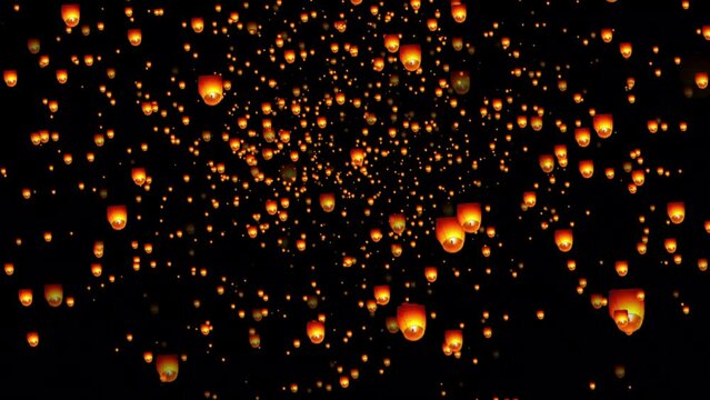 Golden color floating lantern. A large group of Chinese flying lanterns. Chinese sky lanterns floating in a dark night sky. Yee Peng Festival, Loy Krathong celebration.
