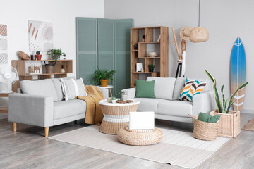 Interior of stylish living room with surfboard