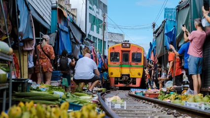 Foto op Canvas Maeklong Railway Market Thailand, Fresh Market on the Railroad Track, Mae Klong Train Station, Bangkok a famous railway market in Thailand © Fokke Baarssen