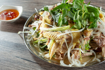 A closeup view of a Vietnamese chicken entree called ga len mam nguyen con.