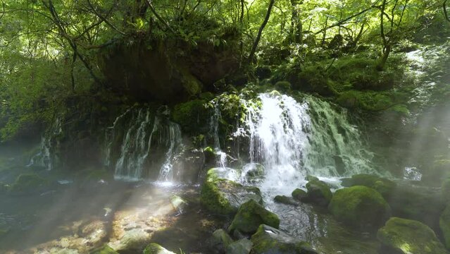 Cinematic gimbal shot of misty Mototaki Fukuryusui Underflow waterfalls in Akita prefecture in Japan