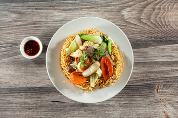 A top down view of a Vietnamese crispy noodle dish called mi xao gion hai san.