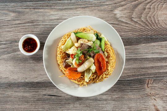 A top down view of a Vietnamese crispy noodle dish called mi xao gion hai san.