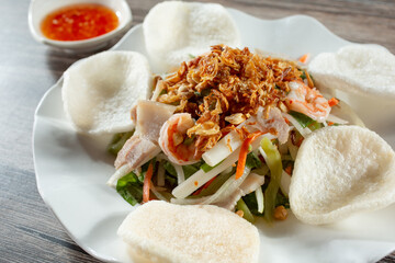 A closeup view of a plate of lotus salad.