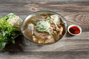 A view of a bowl of beef pho special.