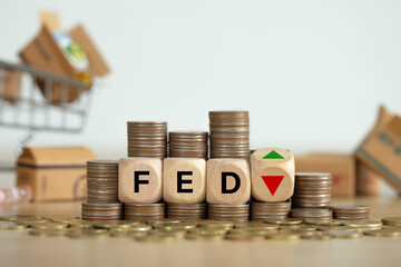 The Federal Reserve ( FED ) to control interest rates. Wooden blocks FED on coins stack. American...